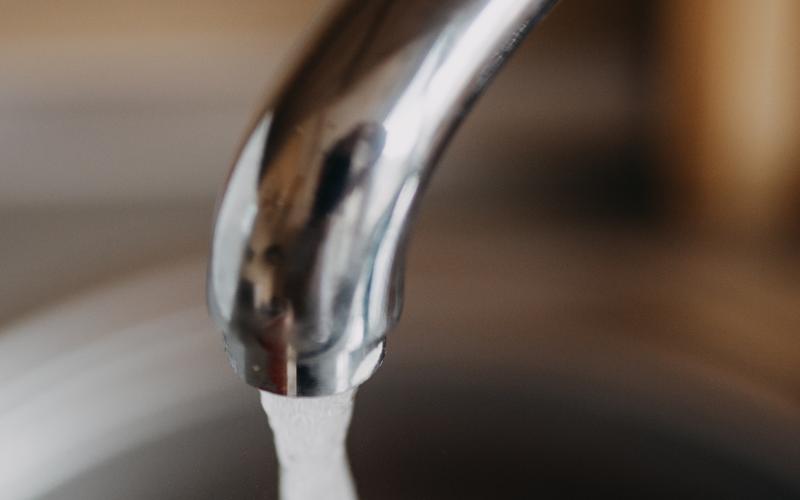Water running from a chrome kitchen faucet